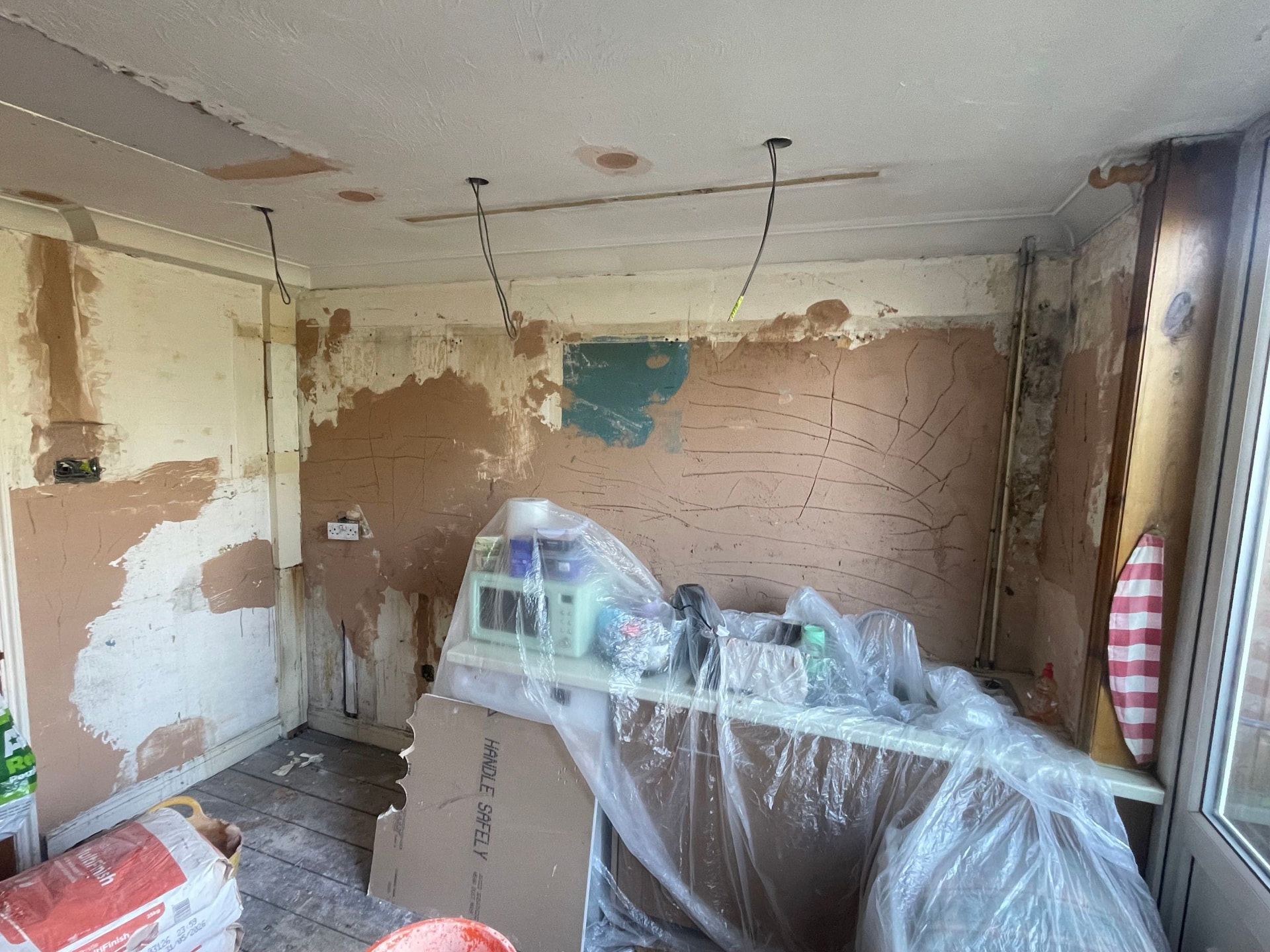 Damp-damaged kitchen walls and ceiling made good before plastering