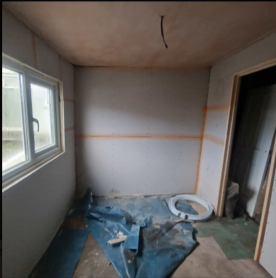 Boarded room taped and skimmed throughout before plastering