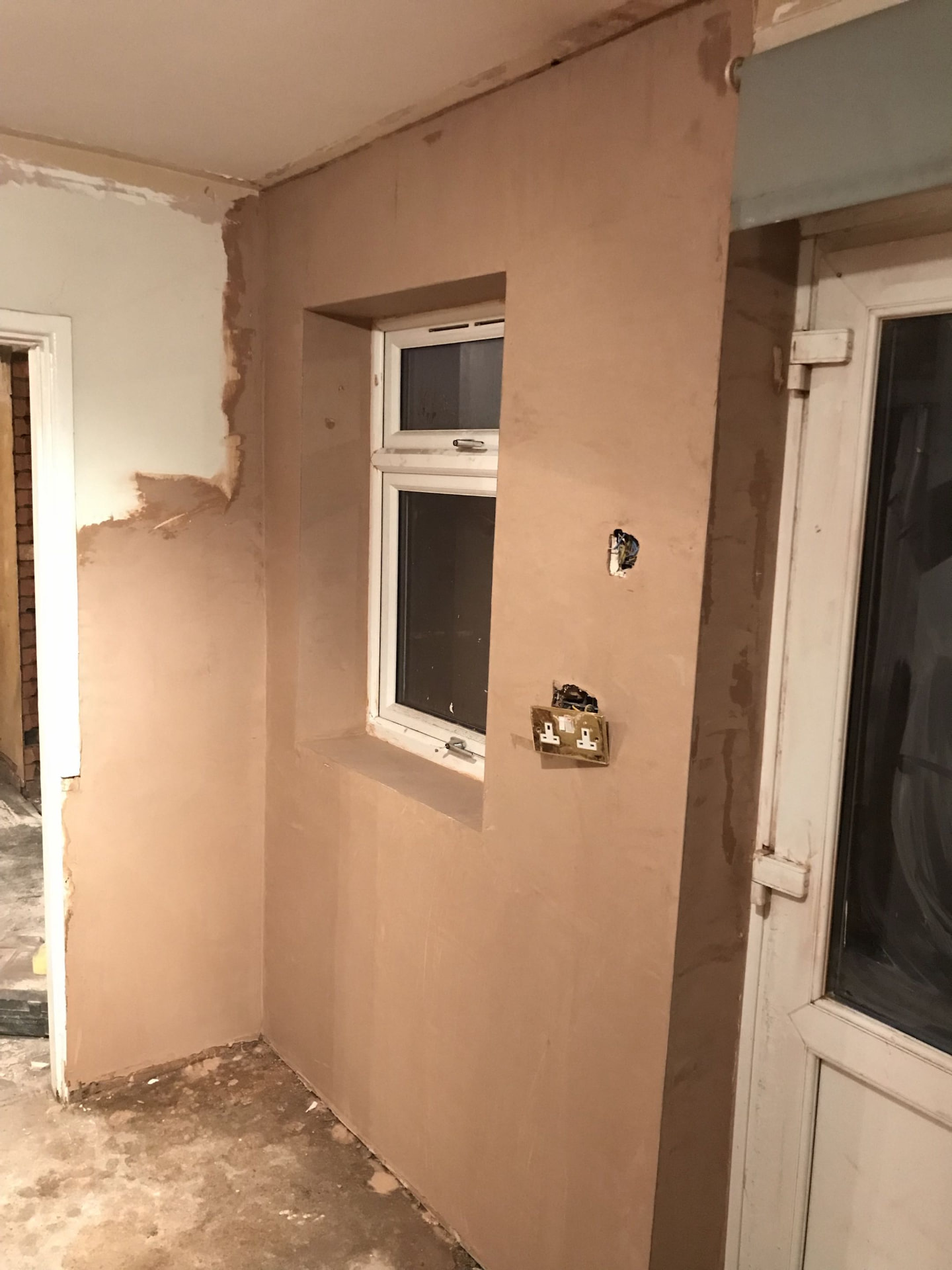 Hallway stripped back to damp brick, replastered clean after plastering