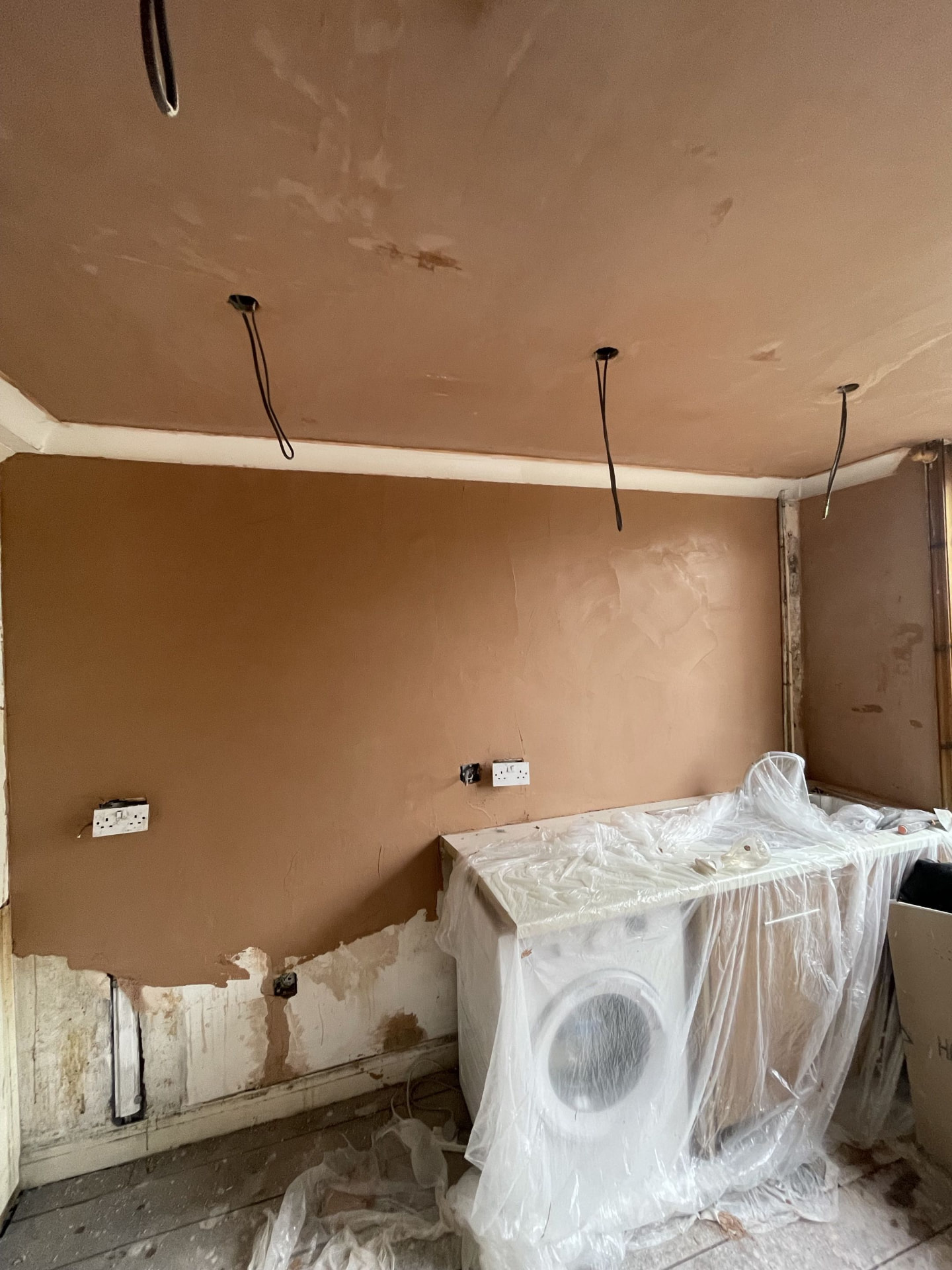 Damp-damaged kitchen walls and ceiling made good after plastering