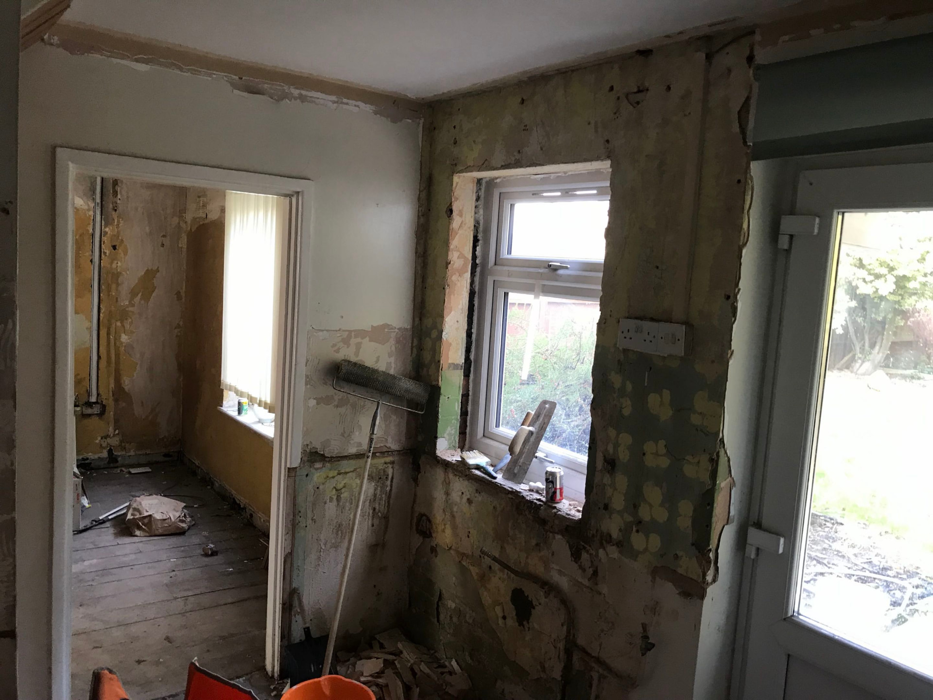 Hallway stripped back to damp brick, replastered clean before plastering