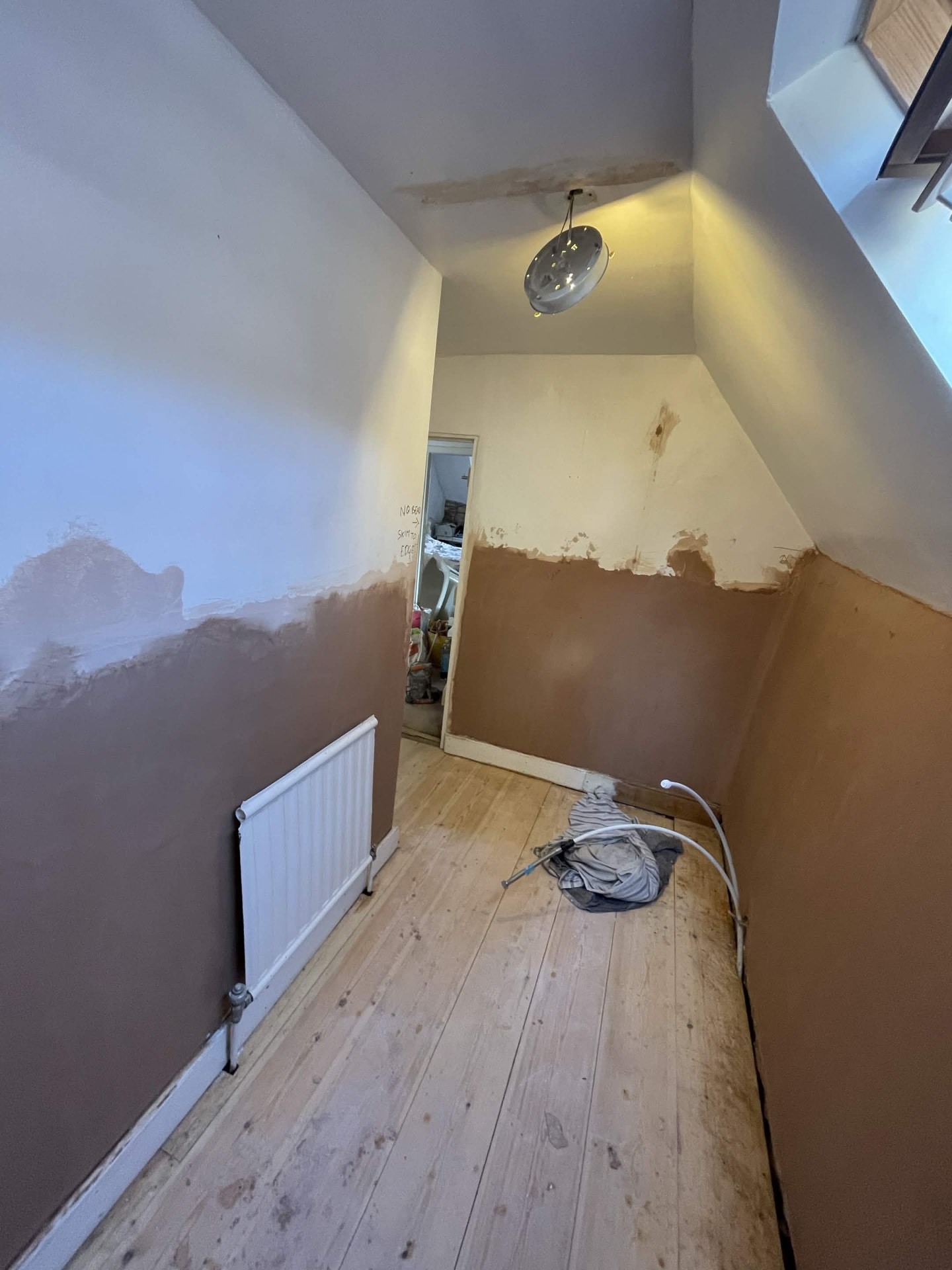 Freshly skimmed bedroom walls with a smooth plaster finish